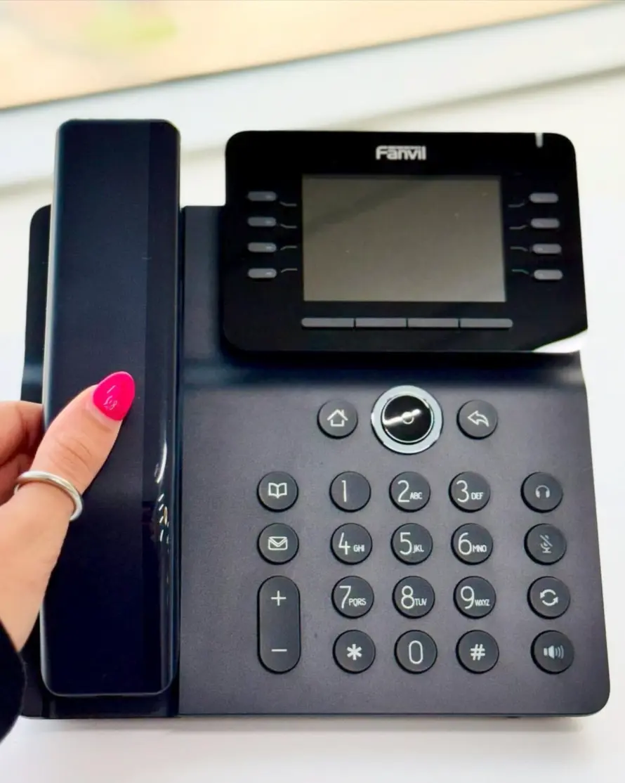 A set of office desk phones arranged together, symbolizing a PBX business phone system for small business communication.
