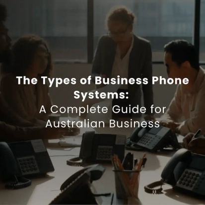 Group of professionals in an office meeting around a table with multiple business desk phones, discussing communication systems.